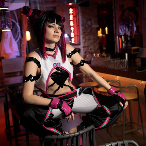 Juri Han displays a confident stance, her expression capturing her intense and rebellious nature. The vivid neon lights and urban setting enhance the edgy vibe of the scene, complementing Juri's bold and striking outfit, complete with pink and black details. The character's daring personality shines through, making this portrayal both captivating and true to the spirit of Juri Han