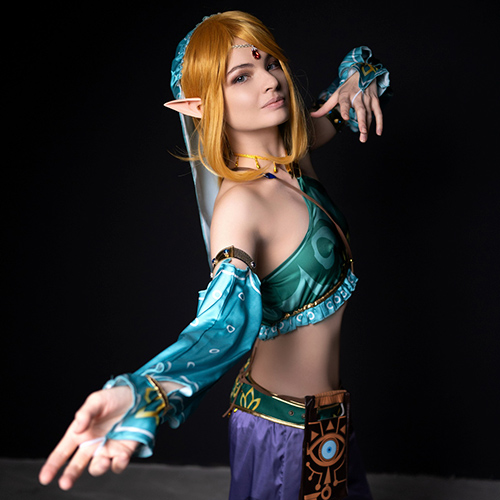 Mesmerizing Gerudo Link cosplay from The Legend of Zelda: Breath of the Wild, striking a graceful pose that highlights the intricate details of the turquoise outfit and accessories. Ideal for fans of Zelda seeking Gerudo-inspired cosplay ideas.