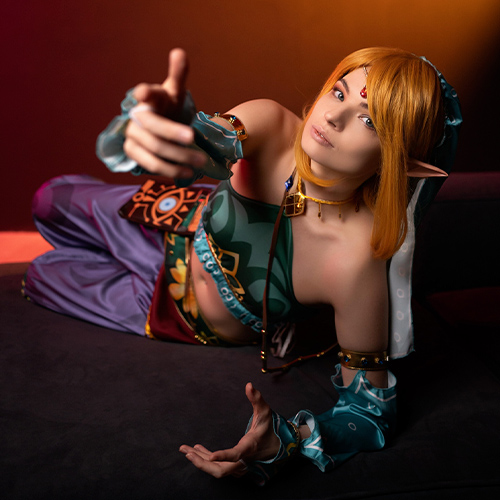 A stunning and sexy female Gerudo Link cosplay from The Legend of Zelda: Breath of the Wild, embodying a seductive and daring twist on the iconic hero. The intricate turquoise and gold details of the Gerudo outfit highlight the character’s adventurous spirit, while her alluring gaze and elf-like features add an enticing charm. This gender-bender cosplay reimagines Link as a fierce, beautiful girl in traditional Gerudo attire, blending elegance and bravery. Perfect for fans seeking a bold, feminine version of this legendary character.