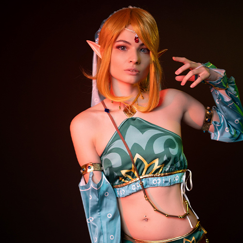 A captivating and sexy female interpretation of Link in Gerudo attire from The Legend of Zelda: Breath of the Wild. This cosplay showcases a beautiful gender-bent version of the iconic hero, adorned with exquisite details that bring a sensual twist to Link's Gerudo disguise. The turquoise and gold accents, paired with alluring elf-like features, emphasize both strength and femininity. Perfect for fans drawn to a daring, seductive take on Link, this female version embodies the adventurous spirit of Hyrule with a uniquely bold, captivating charm