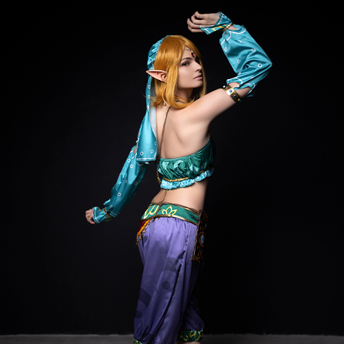 A captivating gender-bent, sexy Gerudo Link cosplay that exudes elegance and strength, bringing a unique female twist to the beloved character from The Legend of Zelda: Breath of the Wild. Dressed in a turquoise and purple Gerudo-inspired outfit, this cosplayer combines grace and power, enhanced by intricate details like elf ears, golden accessories, and a mysterious, alluring pose. Perfect for fans of daring interpretations and creative gender-bender transformations, this female version of Link captures both the character’s essence and a seductive flair. A stunning display for anyone looking to explore the world of Zelda through fresh, imaginative cosplay perspectives.