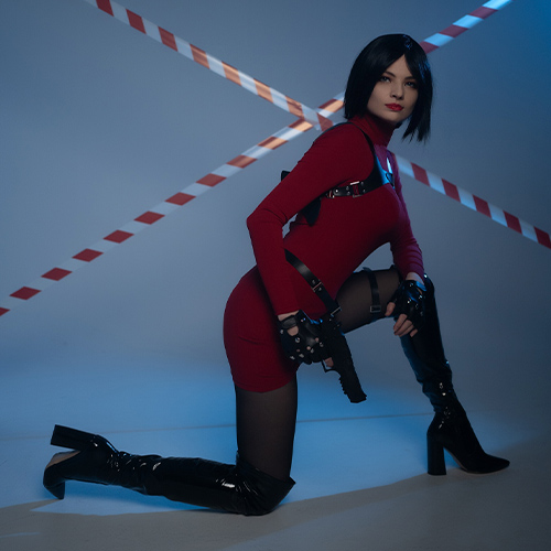 A breathtaking Ada Wong cosplay from the Resident Evil series, featuring the iconic red dress and sleek black hair. The sultry pose highlights the character's mysterious and deadly allure, complete with tactical holsters, black thigh-high boots, and gloves to emphasize her femme fatale persona. Perfectly capturing the essence of the enigmatic spy, this cosplay showcases the elegance and danger associated with Ada Wong. Ideal for fans searching for Ada Wong cosplay ideas, Resident Evil cosplay inspiration, or simply stunning female character portrayals from gaming.