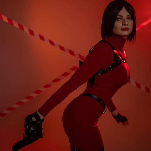 A captivating Ada Wong cosplay from the Resident Evil franchise, featuring the iconic tight red dress paired with sleek black gloves and tactical harness. The dynamic pose with a handgun highlights Ada's stealth and lethal charm, perfectly embodying the mysterious spy’s essence. Set against a dramatic backdrop with red and black tones, this portrayal exudes power, elegance, and danger. Ideal for fans of Resident Evil cosplay, Ada Wong-inspired costumes, and gaming character re-creations.