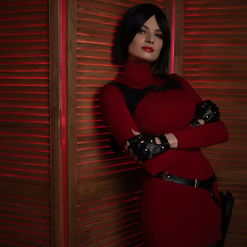 Captivating Ada Wong cosplay from Resident Evil, featuring the character's iconic red dress with a thigh-high slit, black gloves, and high heels. Posing confidently with a gun in hand, embodying Ada's mysterious and elegant spy persona. A detailed and alluring representation of one of gaming's most enigmatic characters.