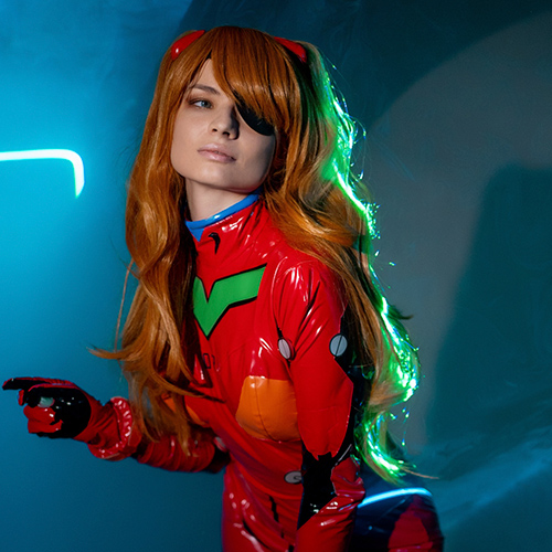 Asuka Langley Soryu cosplay from Neon Genesis Evangelion, showcasing her bold red plugsuit with vivid green and orange accents. The intricate detailing of the suit perfectly mirrors the iconic anime design, highlighting Asuka’s commanding and fearless persona. Her red hair, styled in flowing waves with twin ribbons, captures her energetic and fiery nature. The eyepatch adds depth to her character portrayal, reflecting her resilience. Set against a moody, futuristic backdrop illuminated by neon green light, this cosplay brings a stunning visual intensity, embodying the essence of Asuka's powerful and unforgettable presence.