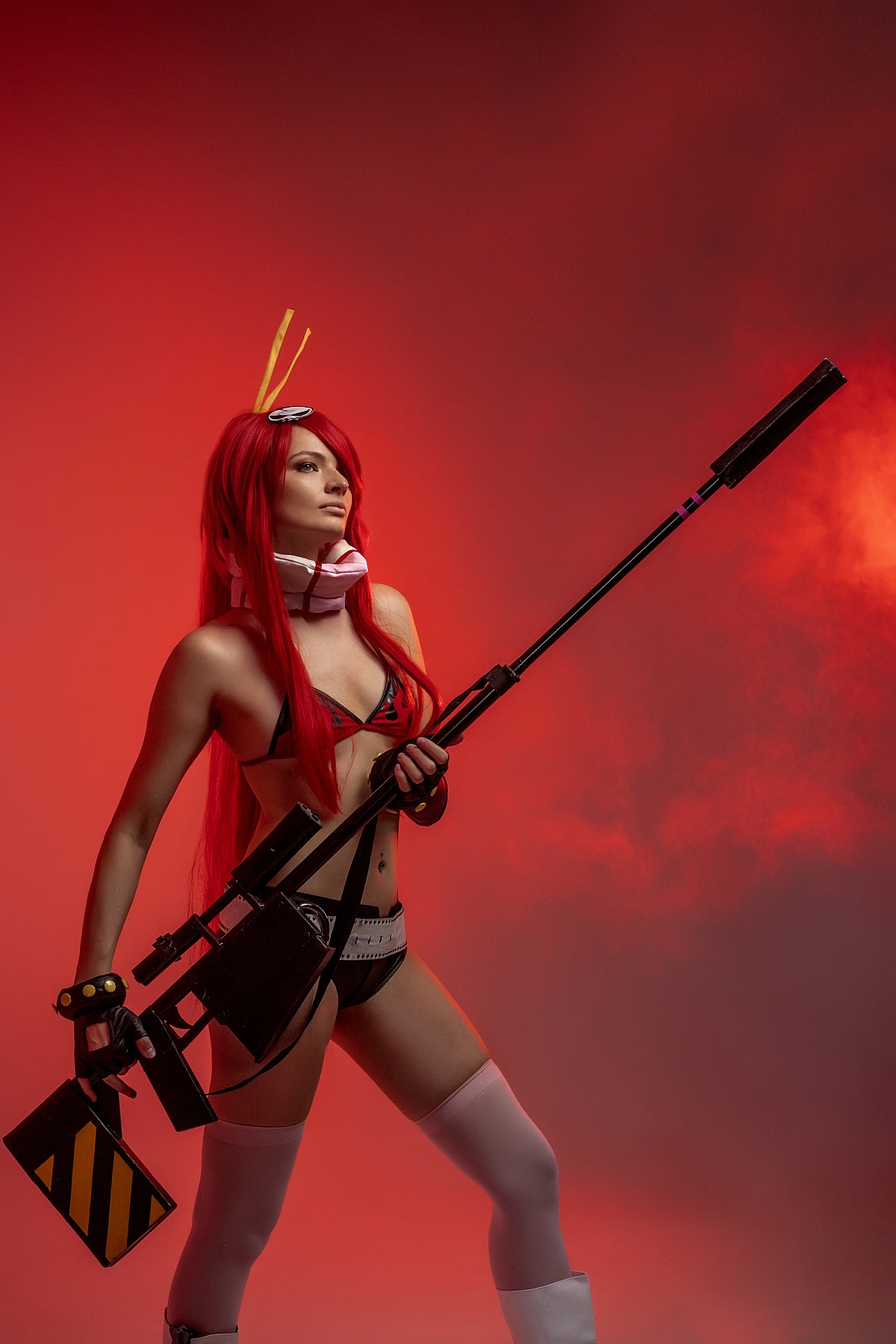 Yoko Littner cosplay full body shot, diagonal sniper rifle pose, crimson red smoke studio, thigh-high stockings, flame bikini, long red hair, anime cosplay
