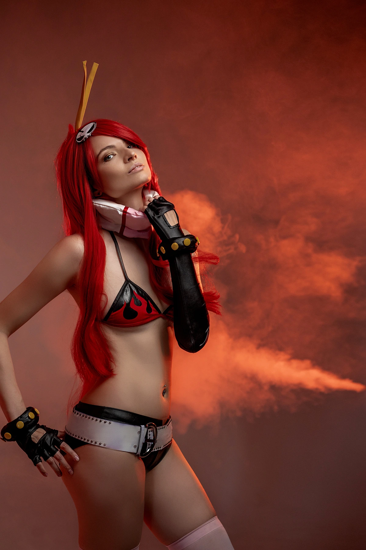 Yoko Littner cosplay portrait red haze studio, flame bikini top, black gloves, wide belt with hardware, thigh-high accents, long red hair, anime girl