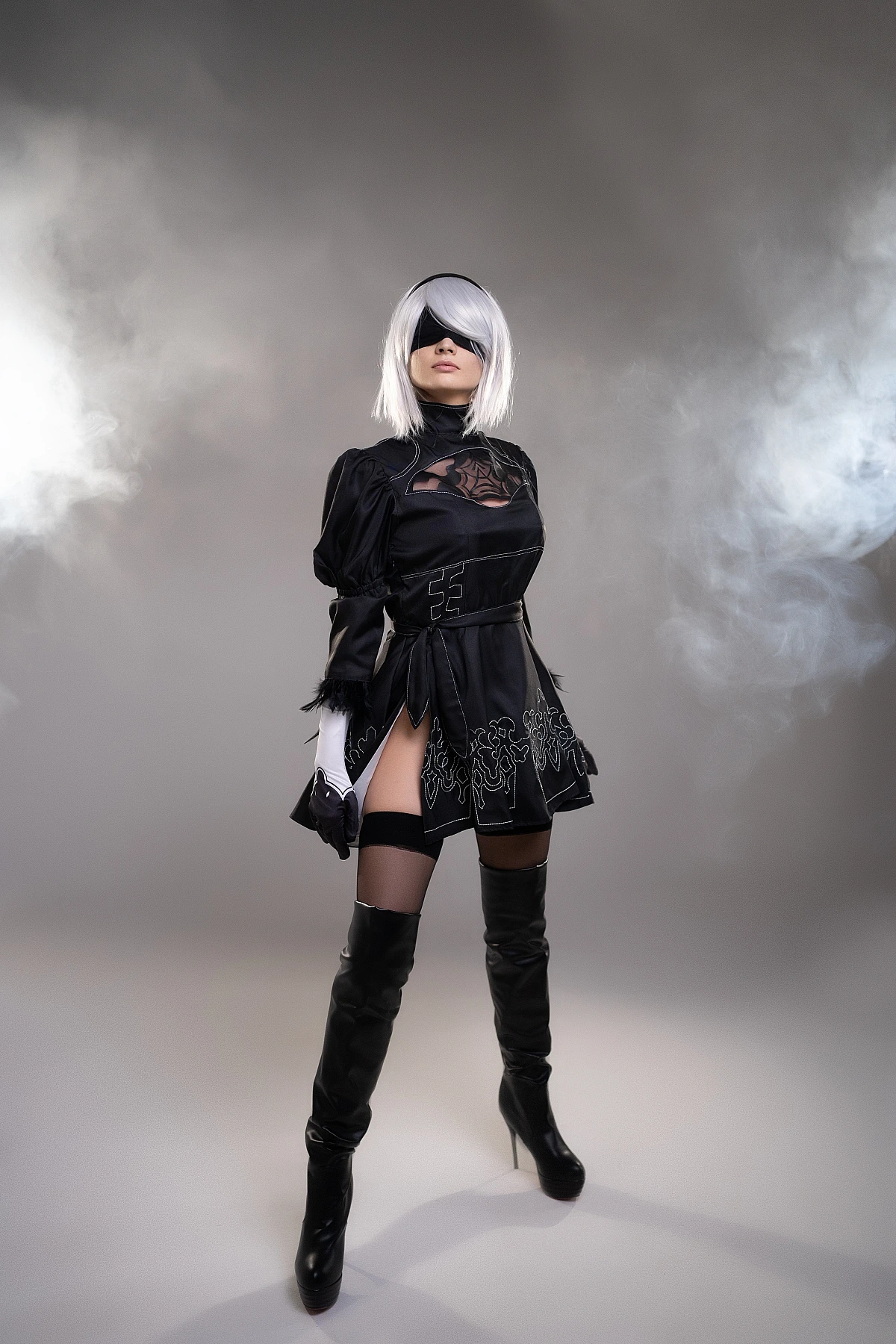 Full body 2B YoRHa cosplay in smoke, silver hair, black blindfold, slit dress and thigh-high boots, NieR Automata