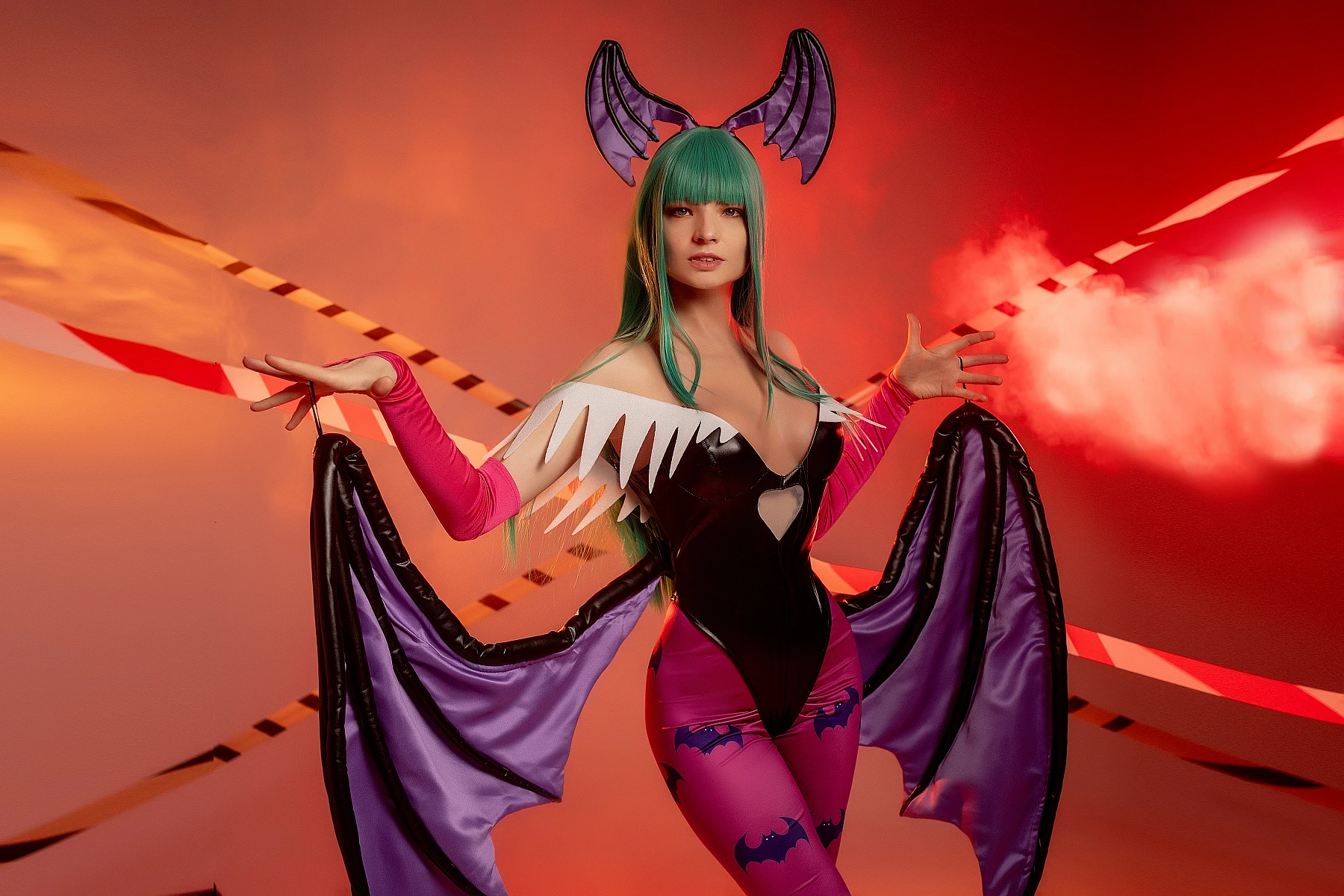 Morrigan Aensland cosplay with red smoke haze, symmetrical wing spread, warm studio lighting, glossy bodysuit, green hair