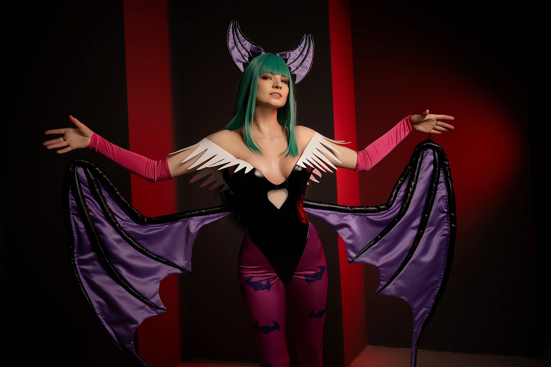 Morrigan Aensland cosplay dark stage lighting, wide wing spread, red vertical accents, glossy bodysuit, dramatic silhouette