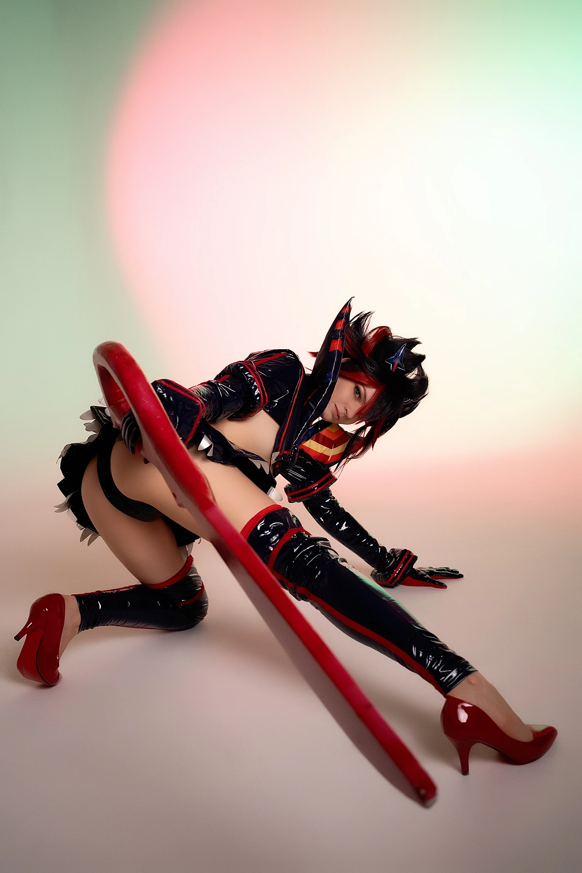 Ryuko Matoi cosplay floor level stretch pose scissor blade foreground soft pastel studio gradient Kill la Kill cinematic