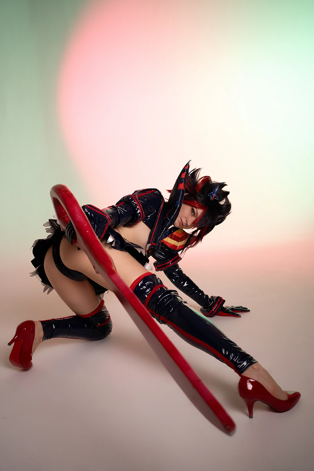 Ryuko Matoi cosplay floor level deep stretch long scissor blade foreground pastel gradient studio Kill la Kill artistic perspective