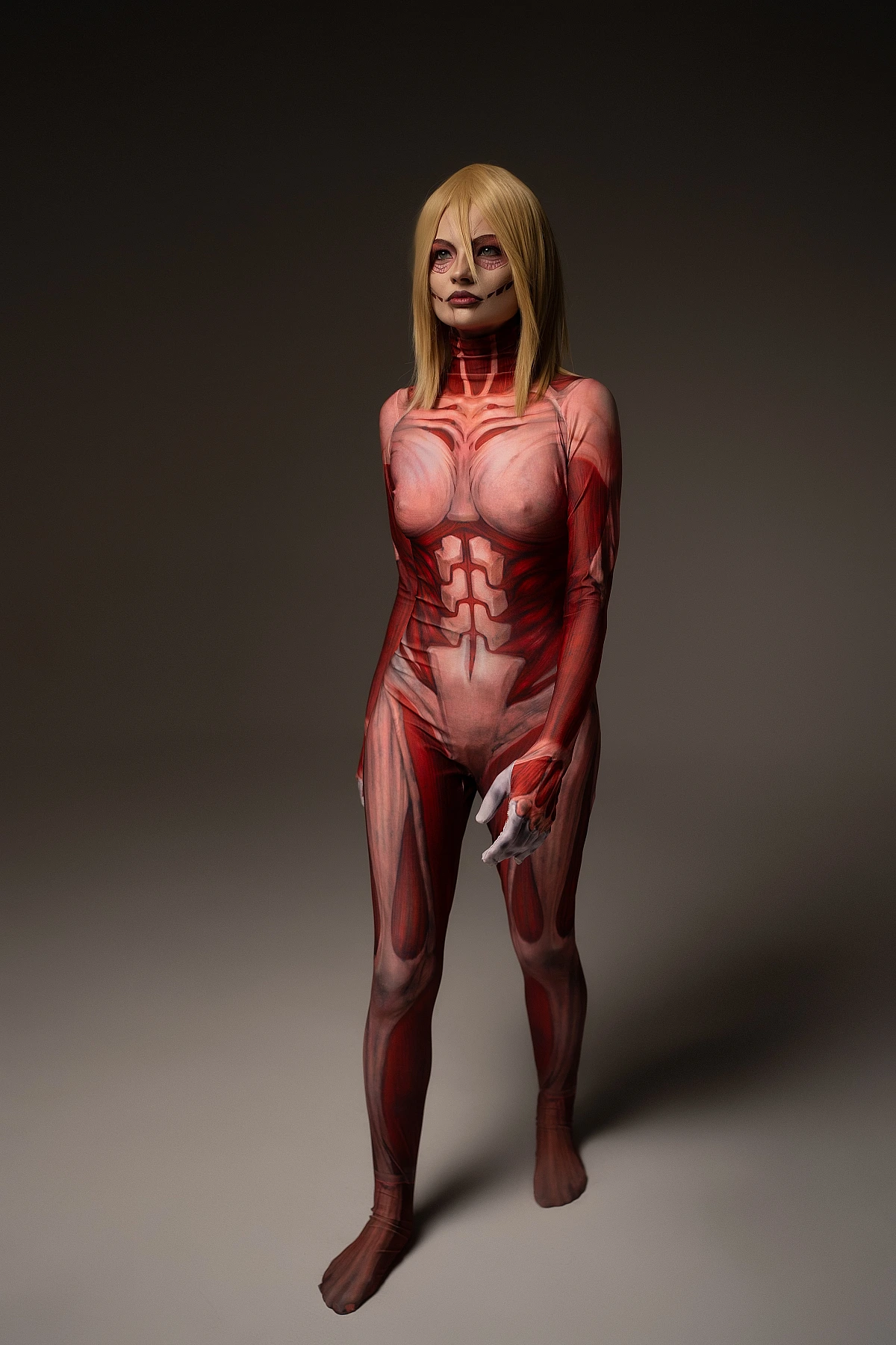 Female Titan cosplay full-length character shot, Annie Leonhart, complete anatomical muscle bodysuit, AOT cosplay reference