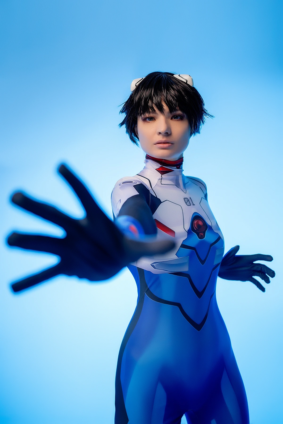femboy Shinji Ikari cosplay reaching forward, blue bodysuit close framing, neon blue studio light, anime femboy photography