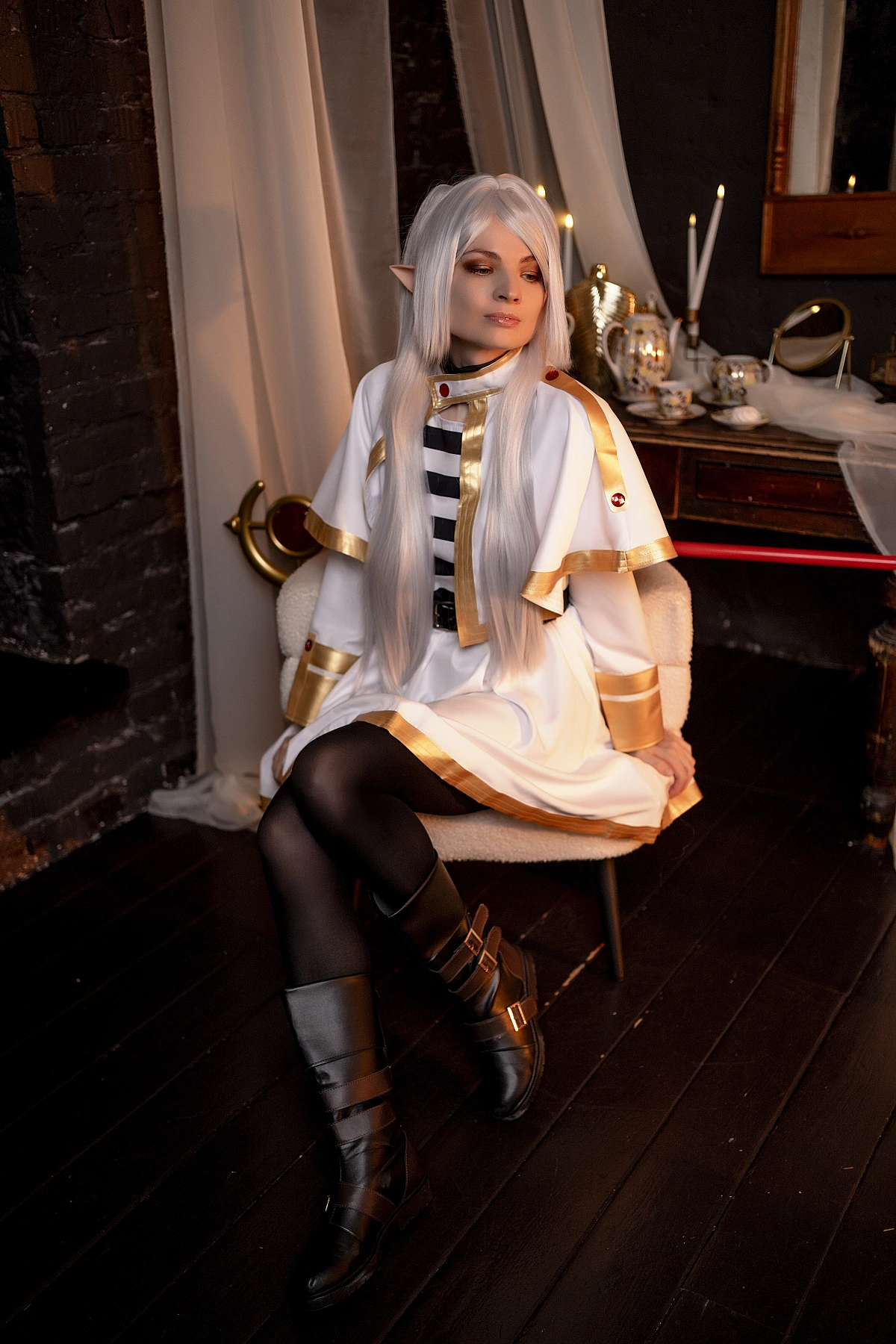 Frieren seated cosplay - relaxed elf mage portrait with candlelight from Sousou no Frieren anime