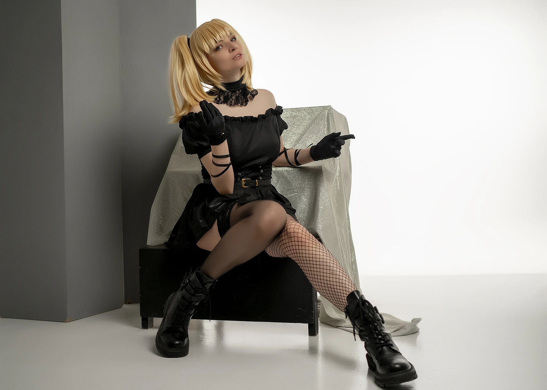 Ani cosplay pointing gesture, diagonal seated pose, black mini dress, lace choker, sheer stockings, playful expression
