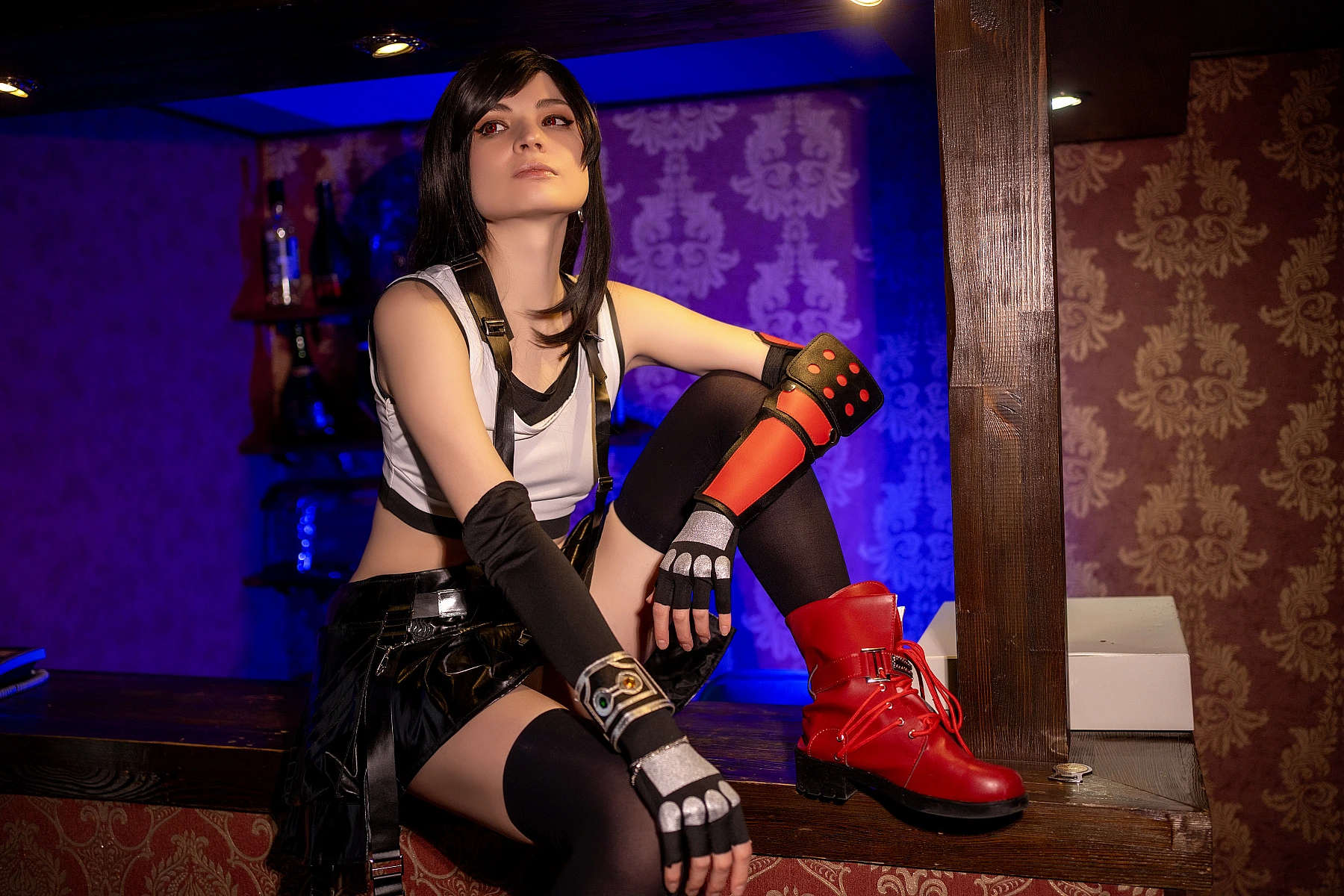 Tifa Lockhart cosplay elegant raised knee bar pose, red boots highlighted, FF7 black skirt costume, cinematic blue and amber contrast lighting