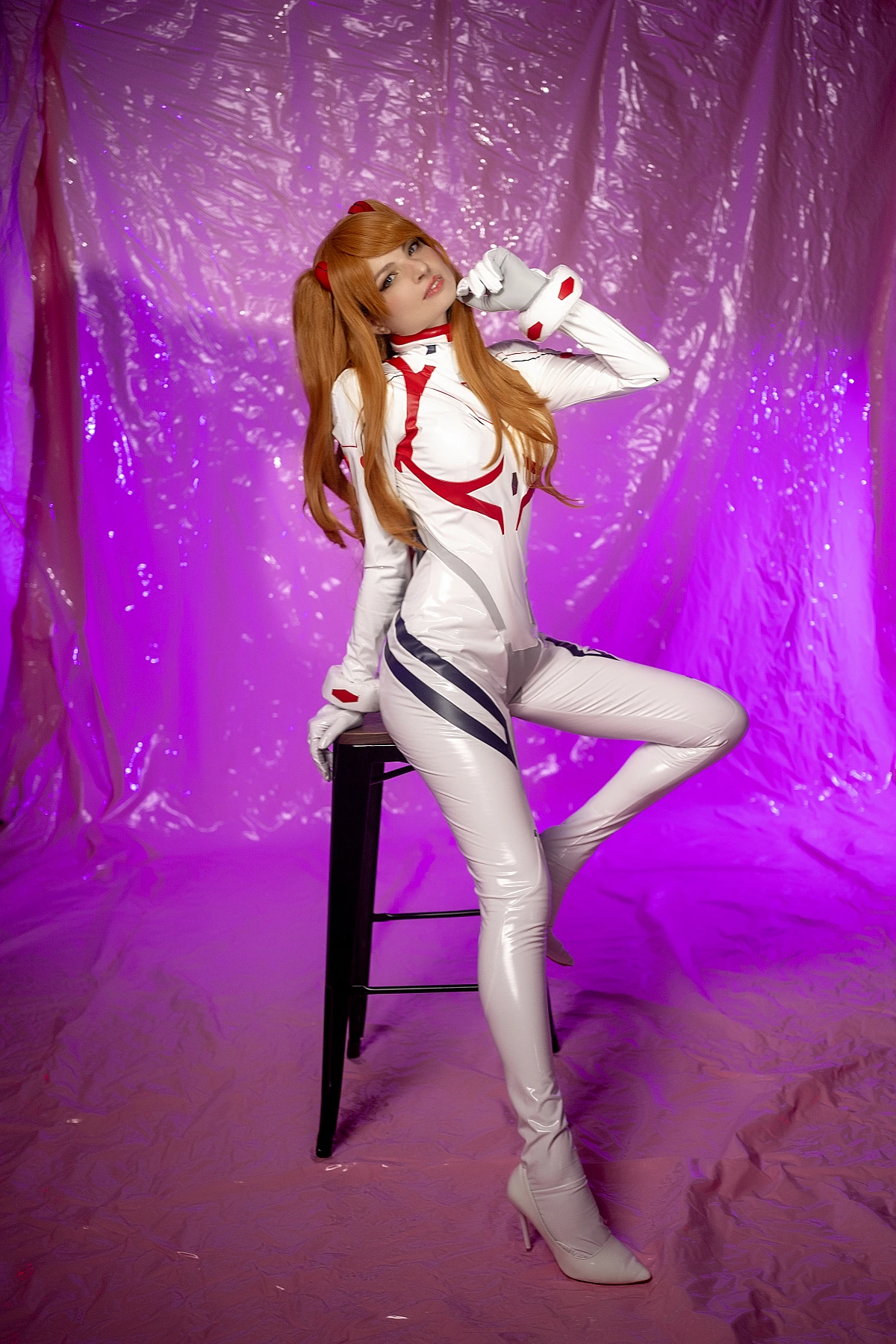 Asuka Langley Cosplay — White Rebuild Plugsuit Three-Quarter Profile, Leaning on Black Bar Stool with Foot on Rung, Over-Shoulder Gaze, Flat Purple Studio Backdrop