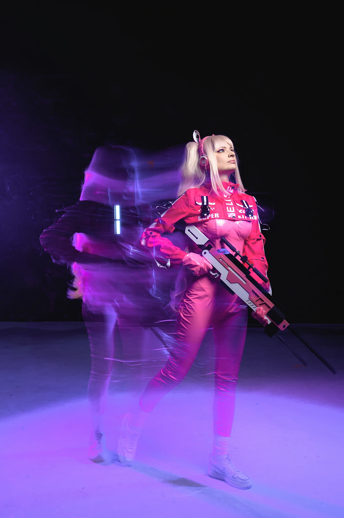 Alice cosplay from Goddess of Victory Nikke with neon motion blur effects and a sniper rifle in a cyberpunk studio setting
