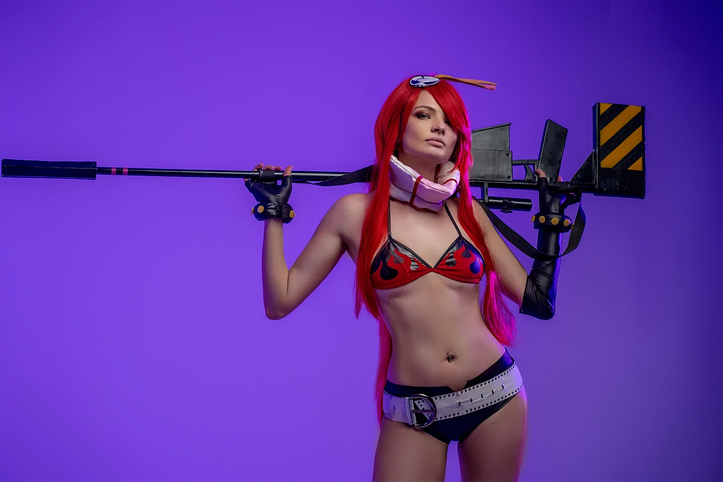 Yoko Littner cosplay girl holding sniper rifle across shoulders, flame bikini top, black gloves, purple neon studio background, professional anime cosplay portrait