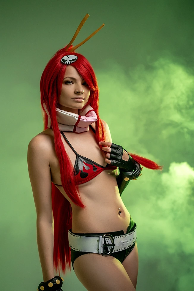 Yoko Littner cosplay portrait emerald green haze, hand touching hair gesture, flame bikini top, wide belt, black gloves, elegant anime girl pose