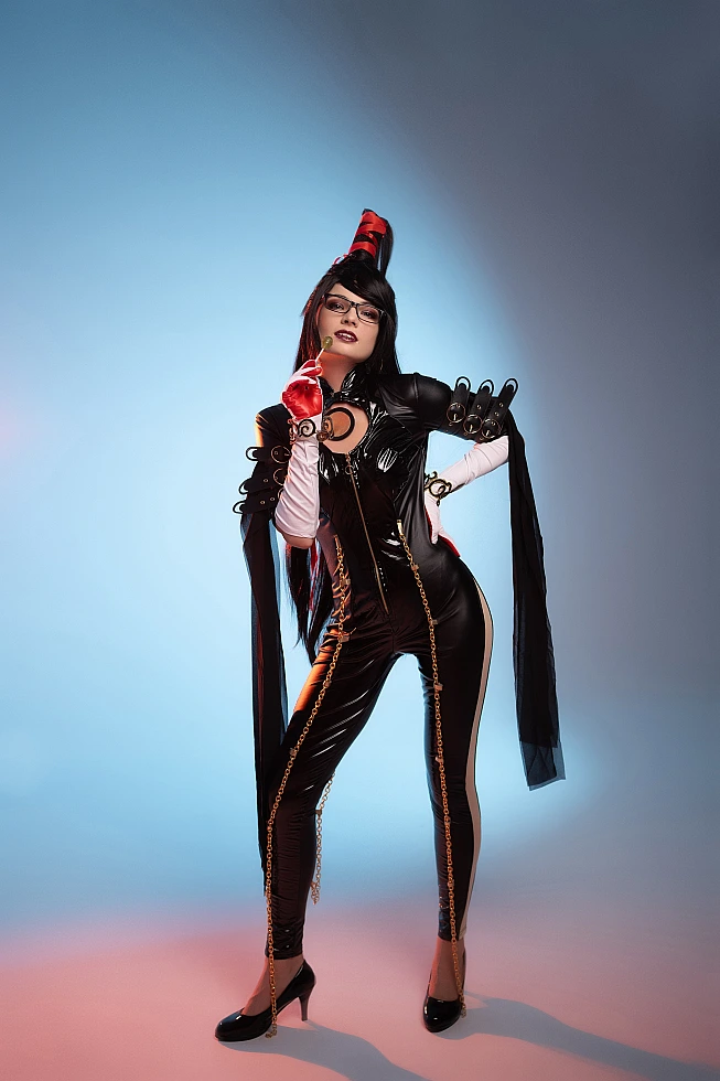 Bayonetta cosplay full-body standing portrait by Neka-Chi, glossy black bodysuit with gold chains, cool blue gradient background