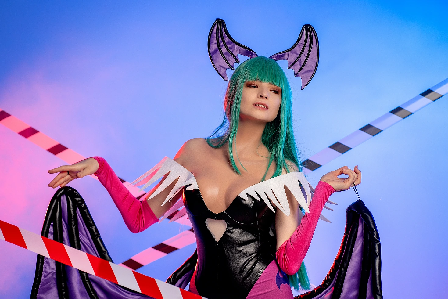 Morrigan Aensland cosplay in blue neon lighting, crossed tape lines, open succubus wings, glossy bodysuit, green hair