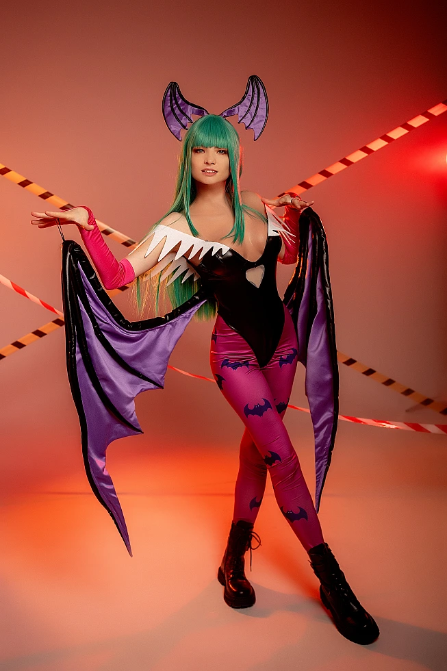 Full-body Morrigan Aensland cosplay front view, open succubus wings, warm studio lighting, glossy bodysuit, green hair