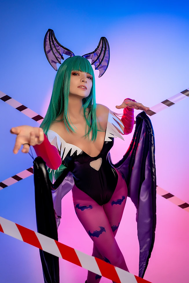 Morrigan Aensland cosplay neon blue-pink lighting, forward hand gesture, crossed tape, succubus wings, glossy bodysuit