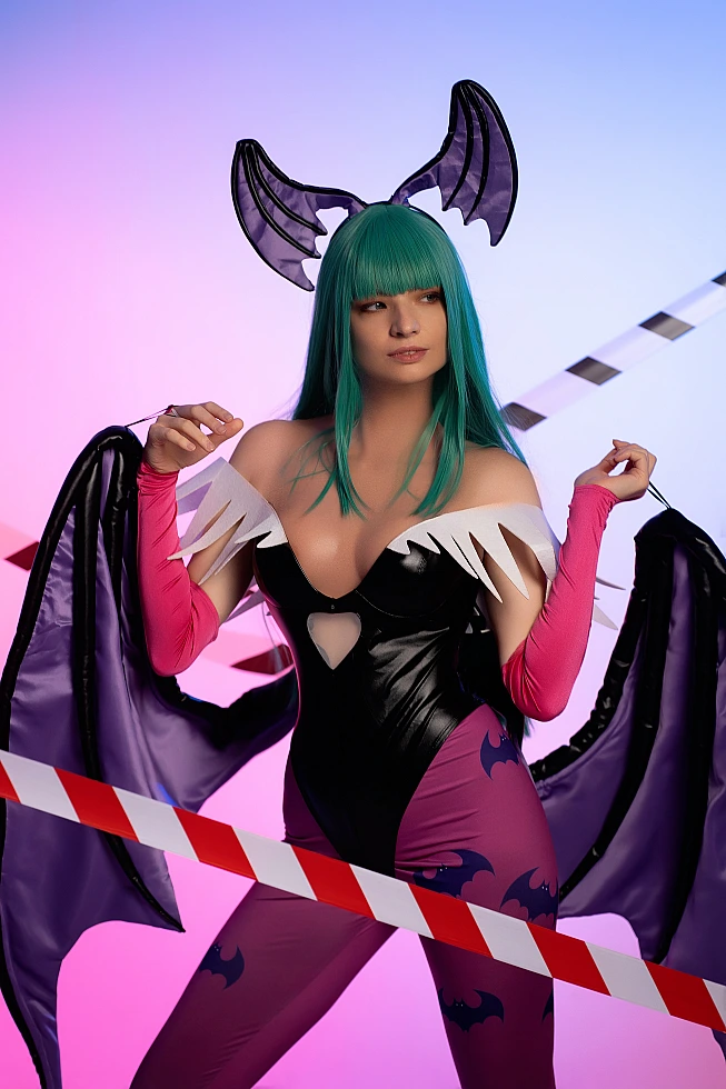 Morrigan Aensland cosplay side glance, pastel neon blue-pink background, open wings, glossy bodysuit, green hair