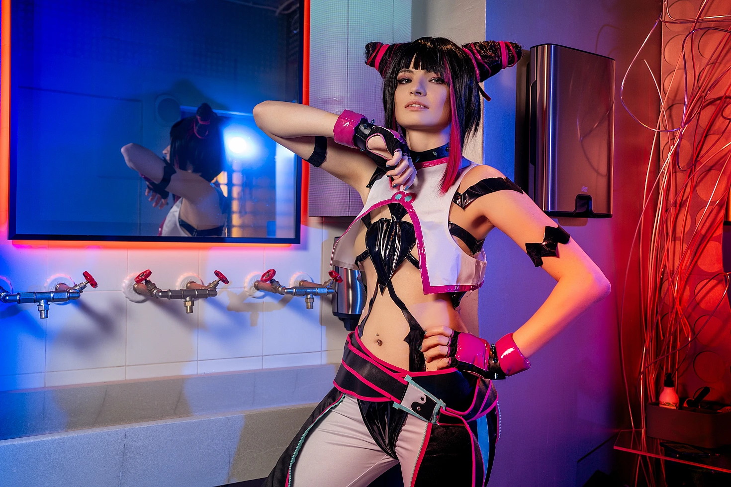 Juri Han cosplay portrait by bathroom sink with mirror reflection, blue and magenta neon lighting, raised arm pose