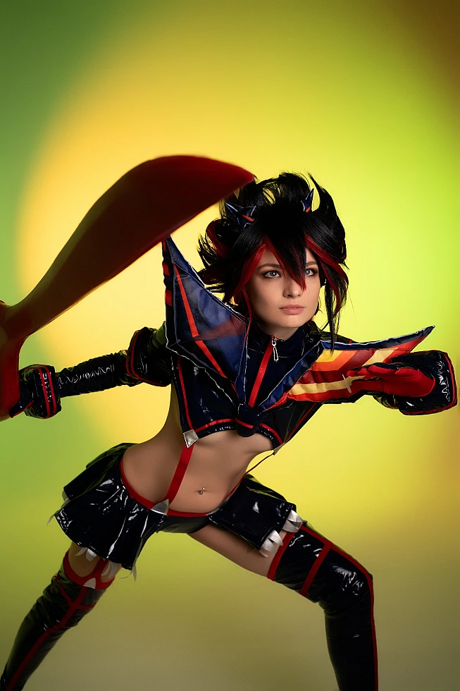 Ryuko Matoi cosplay close-up combat pose raised scissor blade neon green studio gradient Kill la Kill battle ready