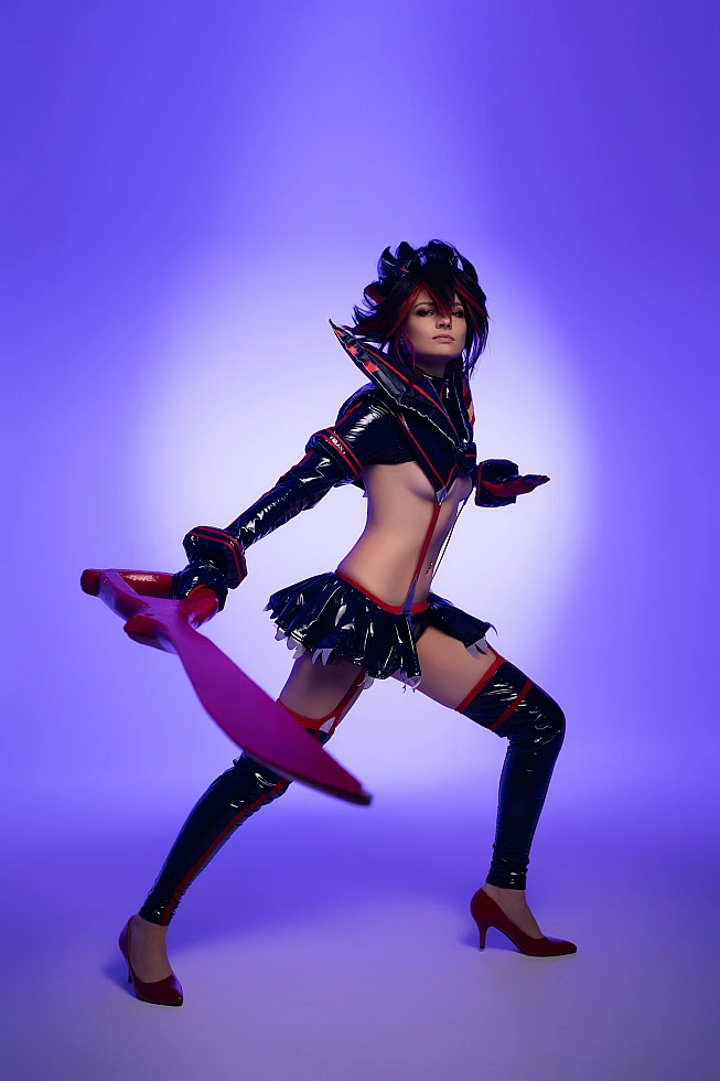Ryuko Matoi cosplay wide action stance sweeping scissor blade motion violet studio background glossy outfit Kill la Kill combat