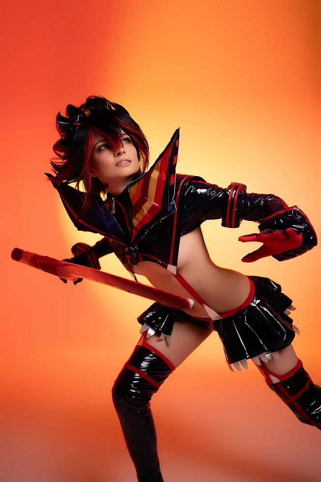 Ryuko Matoi cosplay forward lean action pose scissor blade direction warm orange studio lighting glossy Senketsu Kill la Kill