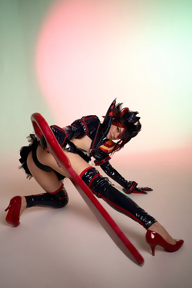 Ryuko Matoi cosplay floor level deep stretch long scissor blade foreground pastel gradient studio Kill la Kill artistic perspective