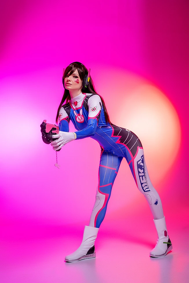D.Va Overwatch cosplay full body blaster pose pink neon lighting blue bodysuit professional gaming photography