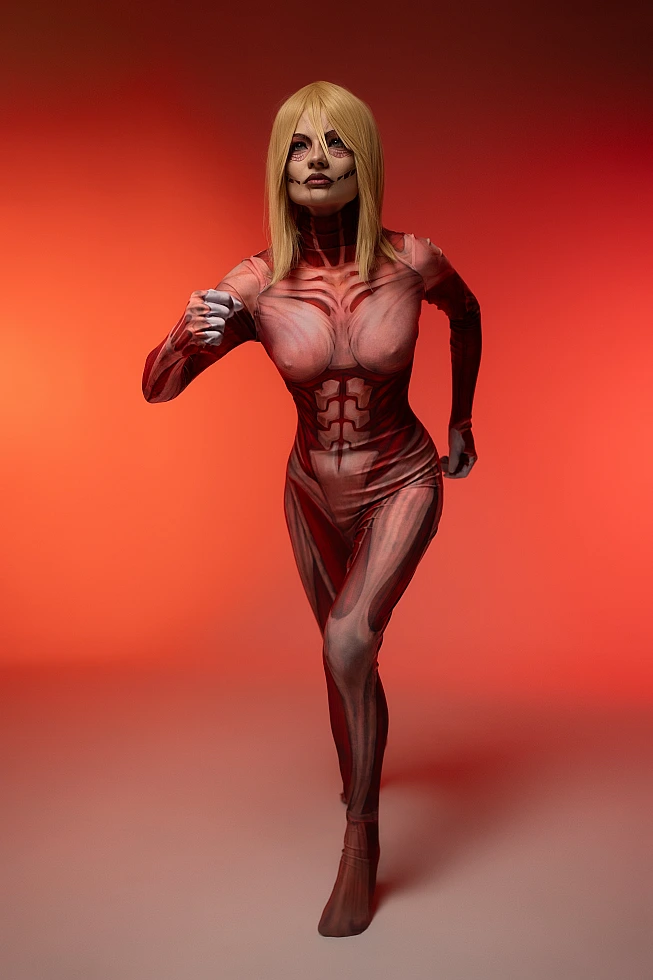 Female Titan cosplay charging forward, Annie Leonhart, clenched fist, red background, Attack on Titan cosplay