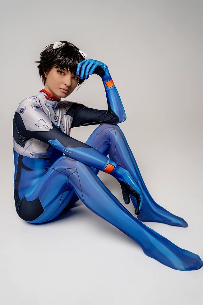 androgynous Shinji Ikari femboy cosplay, blue catsuit floor pose, anime crossplay, gloved hands, studio photography