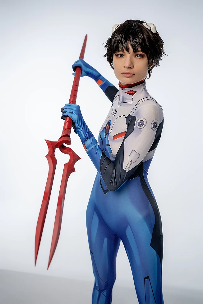 androgynous Shinji Ikari cosplay with Lance of Longinus red spear, blue bodysuit, Evangelion anime cosplay photoshoot