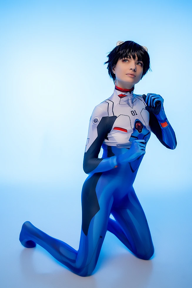 femboy Shinji Ikari cosplay kneeling, blue plugsuit, cool neon blue studio lighting, anime femboy trap photography