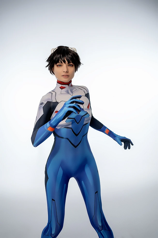 trap Shinji Ikari cosplay standing, blue bodysuit, subtle gesture, white studio background, anime trap crossplay photography