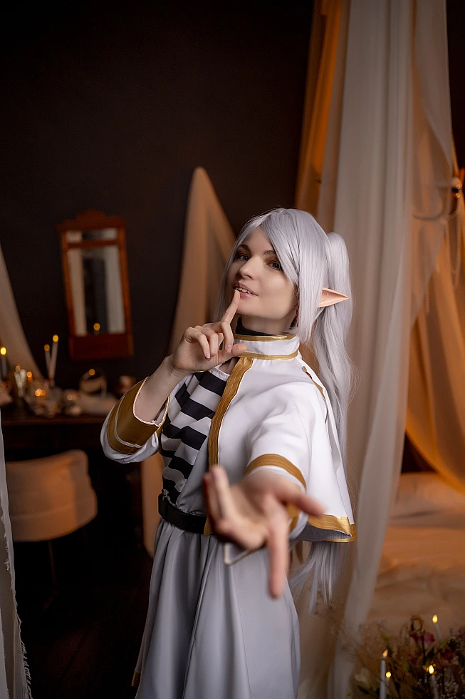 Frieren cute cosplay - playful elf mage with finger to lips pose from Sousou no Frieren