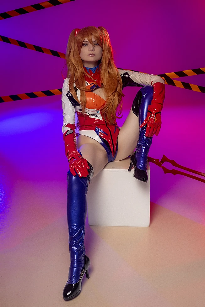 Androgynous femboy Asuka cosplay portrait in latex plugsuit with soft makeup