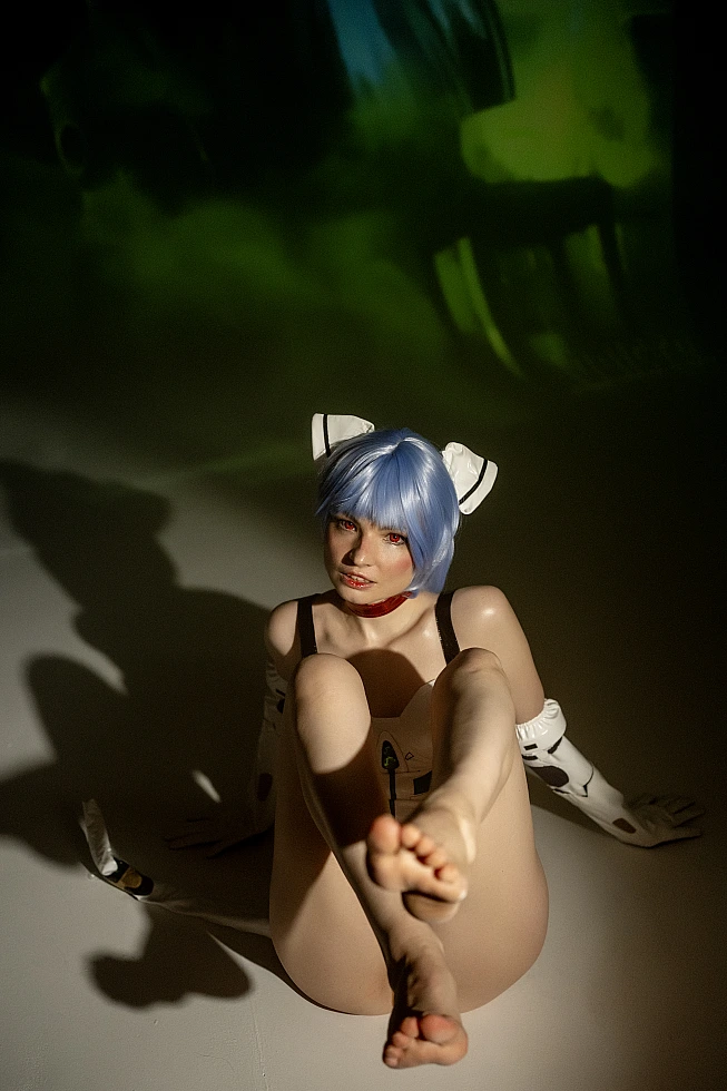 Rei Ayanami cosplay close-up of feet with green neon lighting and white plugsuit