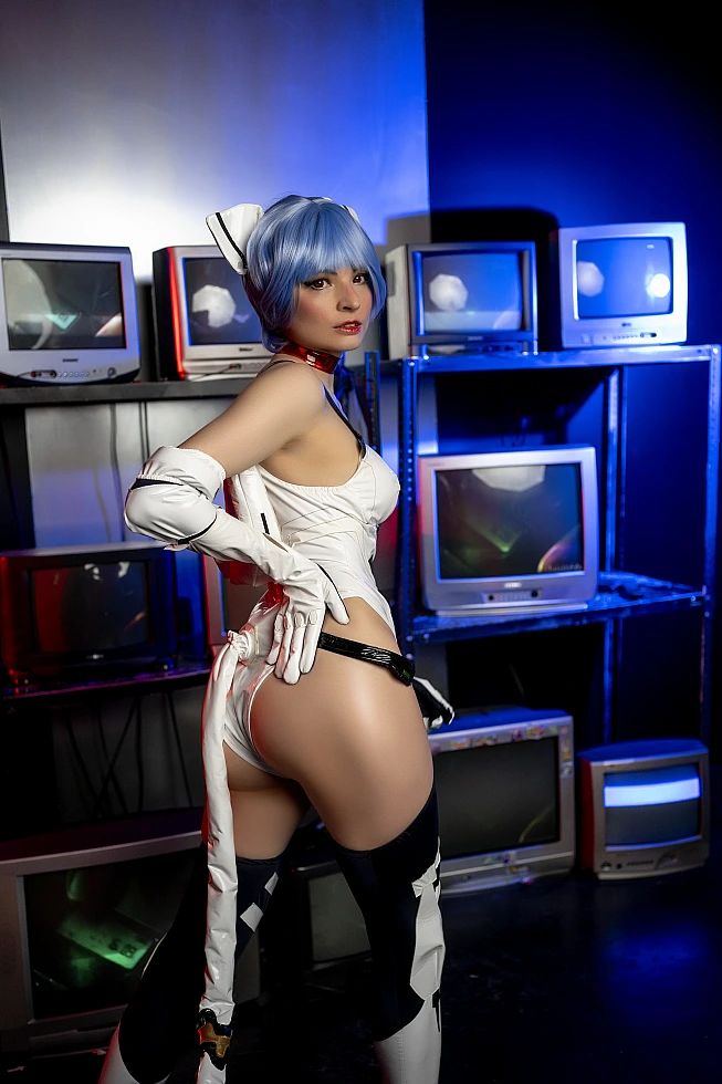 Rear view of Rei Ayanami cosplay in white EVA plugsuit with blue neon studio lighting